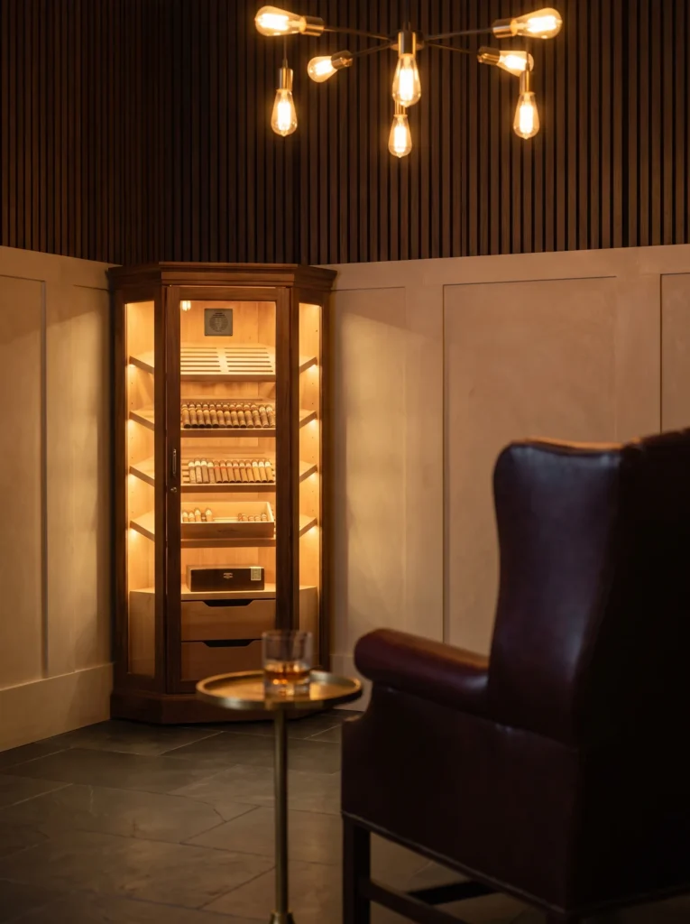 "Cigar lounge with stone wainscoting and glass-front humidor"