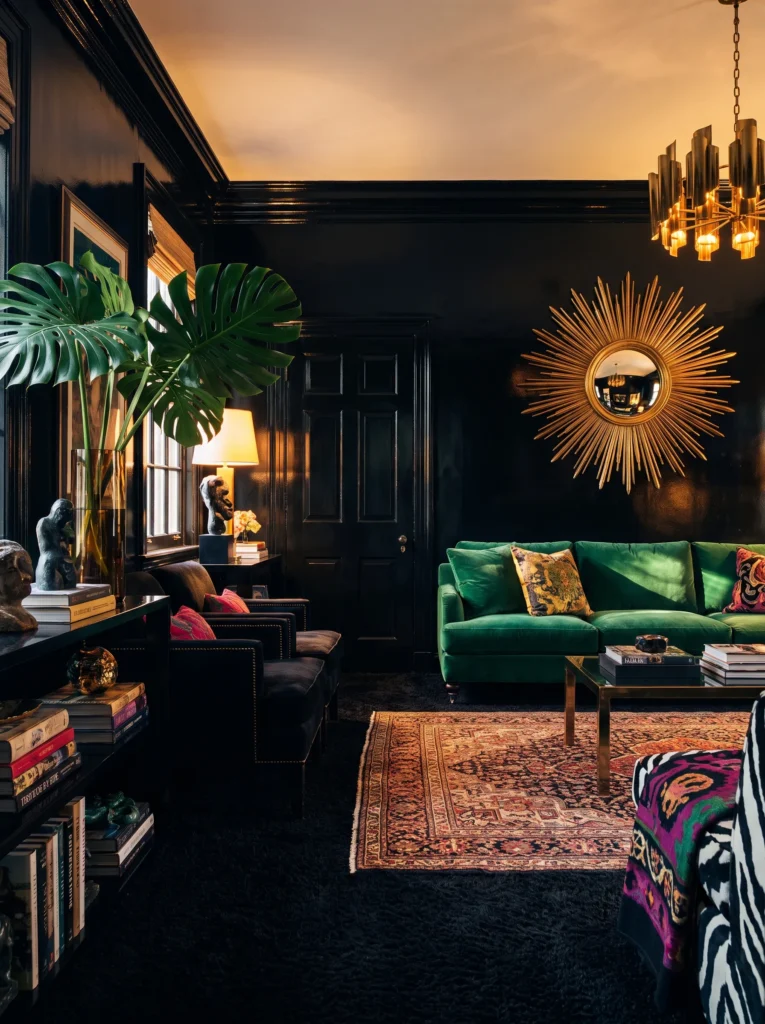 Glossy black living room with emerald velvet sofa and brass sunburst mirror