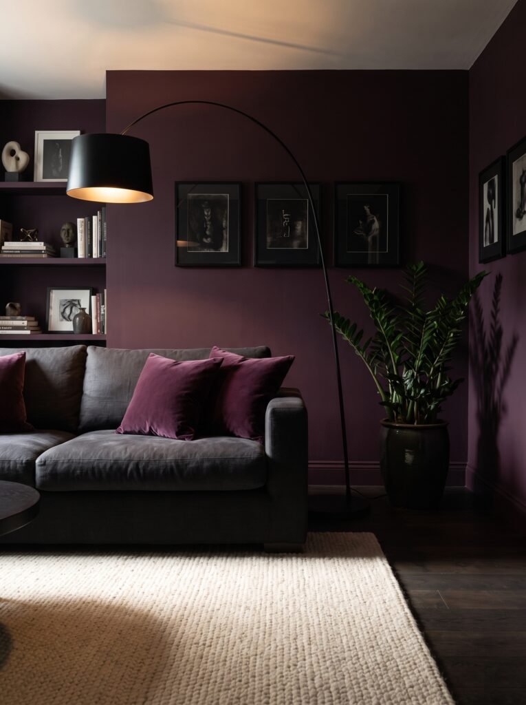 Plum living room with black arc lamp and cream rug layered over dark flooring