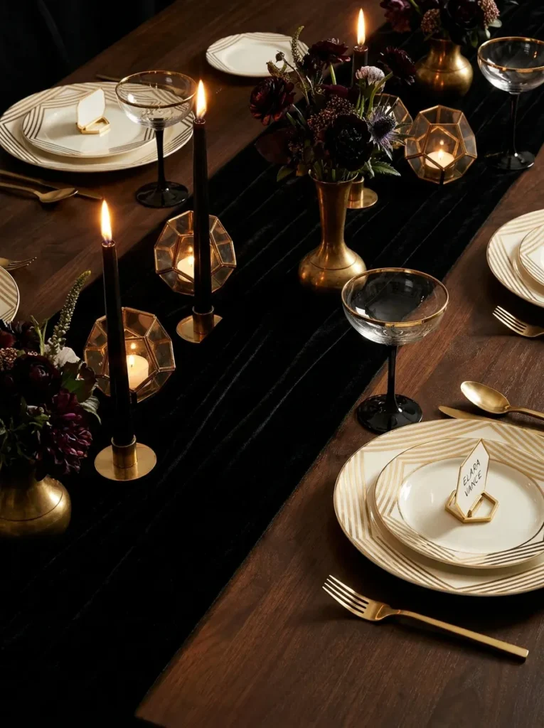 Black velvet runner with ivory-and-gold striped china and black-stemmed coupe glasses