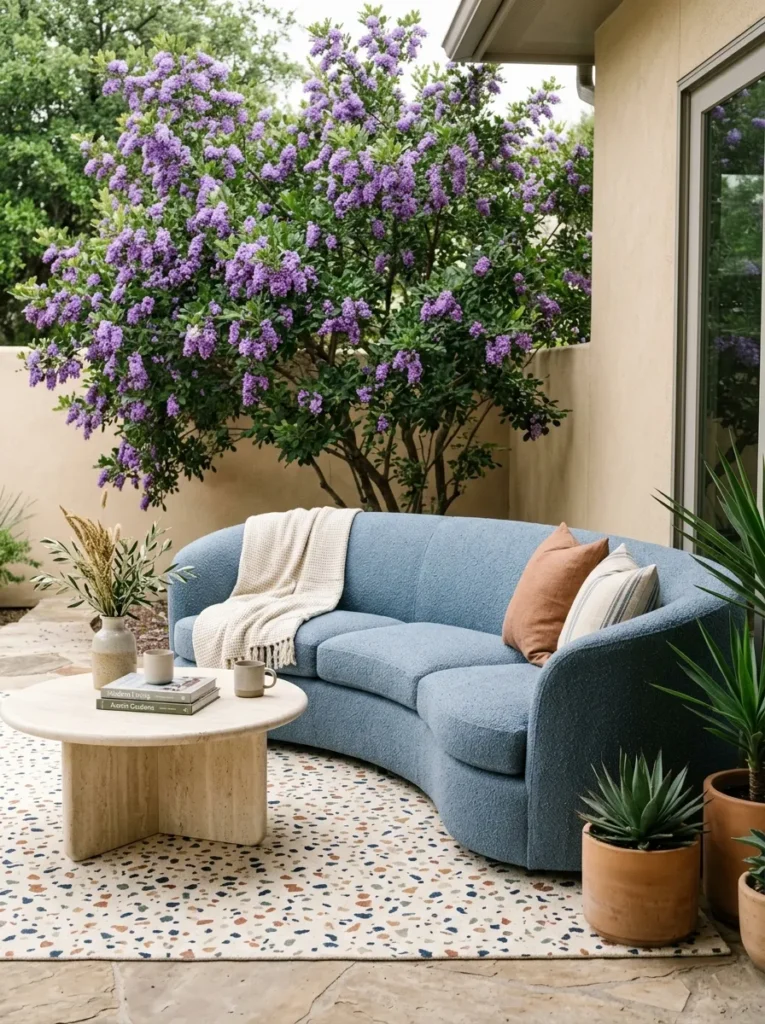 Terrazzo rug and dusty blue loveseat on a patio retreat"