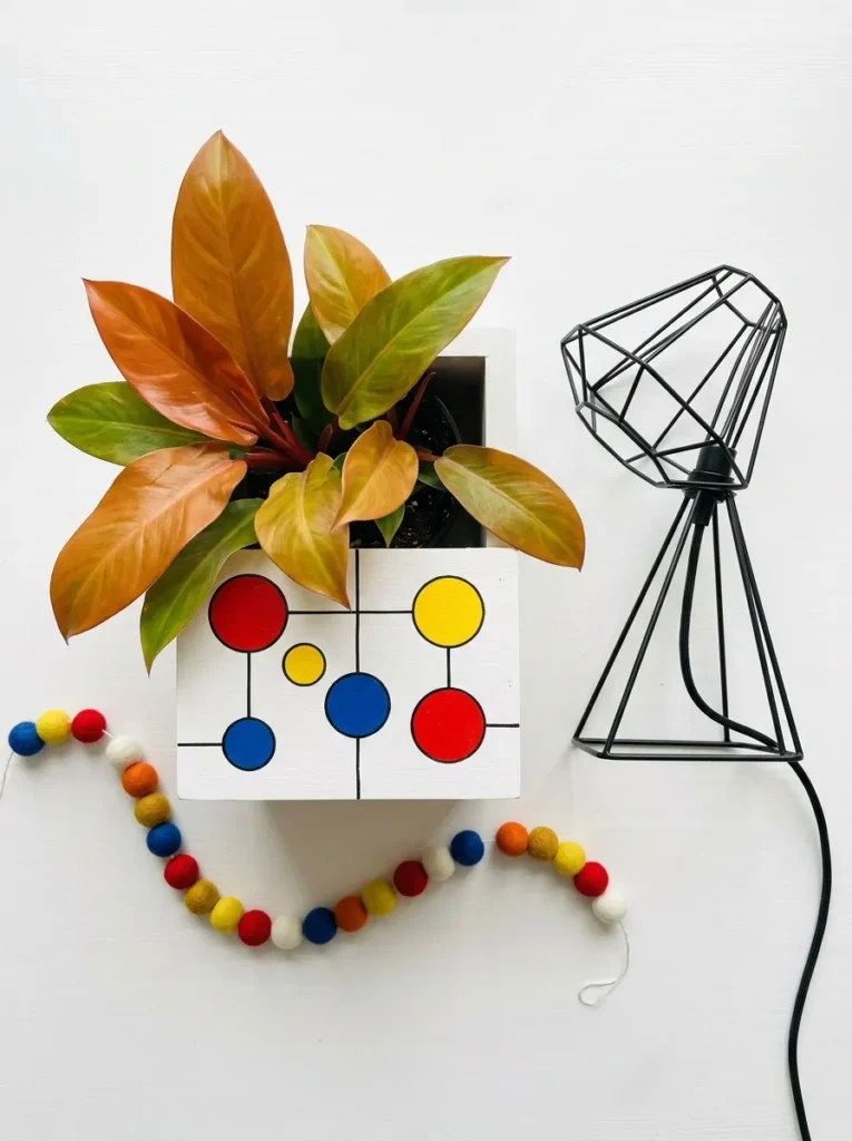 "Calder-inspired floating disc pattern on a wood planter"